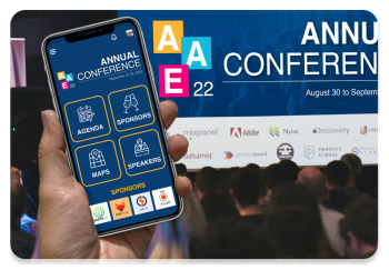 Mobile phone with event app held up with crowd viewing matching live display on conference screen Mobile phone with event app held up with crowd viewing matching live display on conference screen
