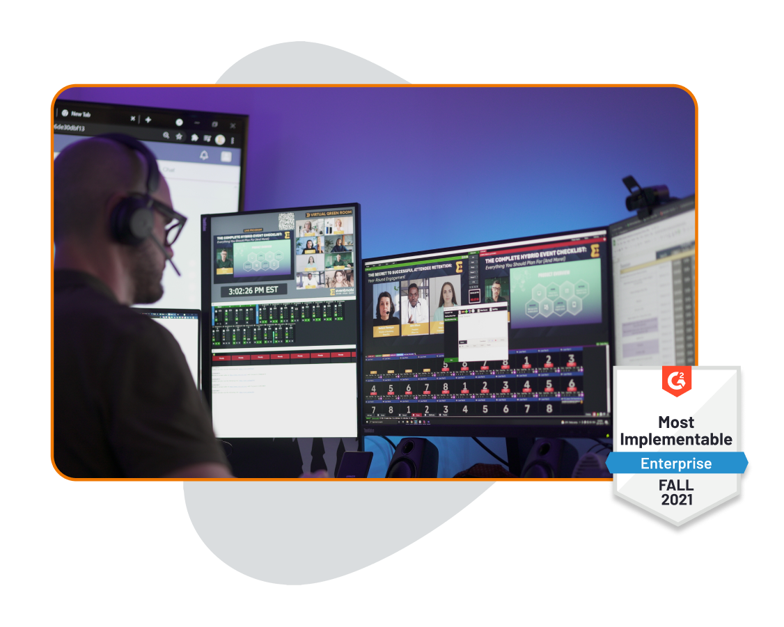 A man in the backstage with a headset in front of a computer, with a G2 Most Implementable Enterprise Fall 2021 badge to one side A man in the backstage with a headset in front of a computer, with a G2 Most Implementable Enterprise Fall 2021 badge to one side